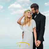 affectionate wedding couple in suit and white dress holding hand